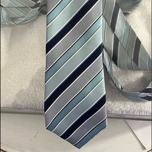New condition mens striped tie in shades of blue.